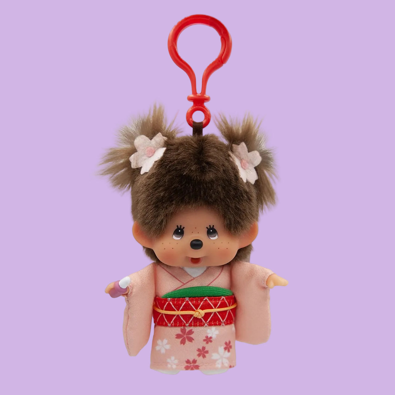 A Monchhichi keychain wearing a kimono. She has flowers in her hair.