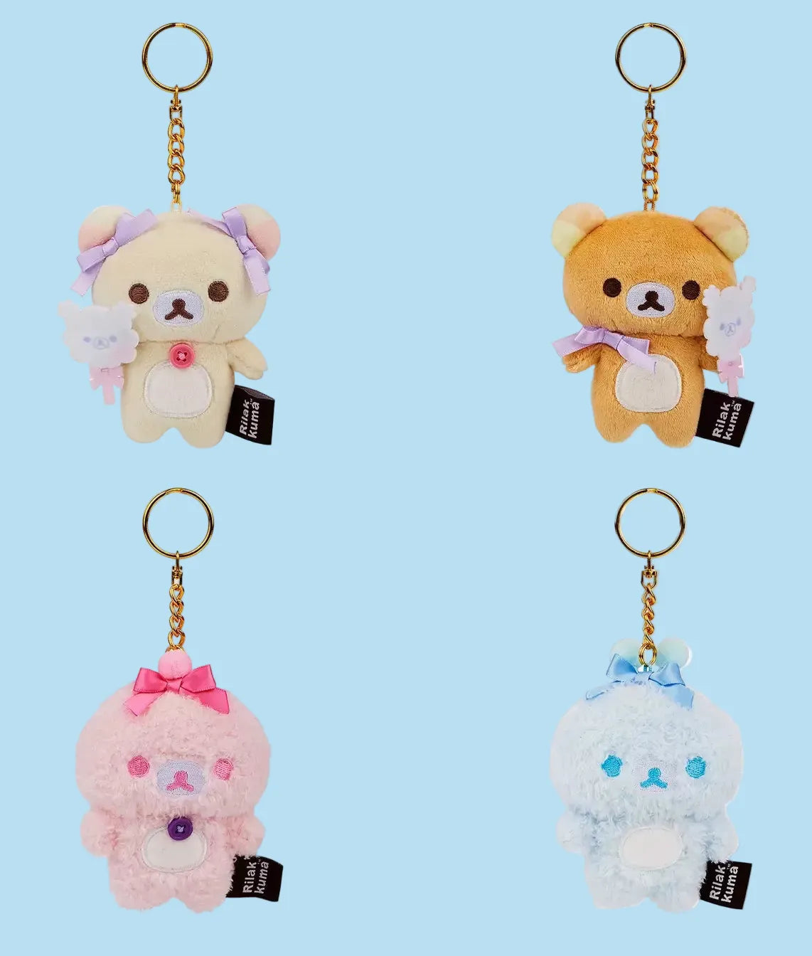 Four design keychains front view; a Korilakkuma holding cotton candy, Rilakkuma holding cotton candy, pink, and blue mini plush.