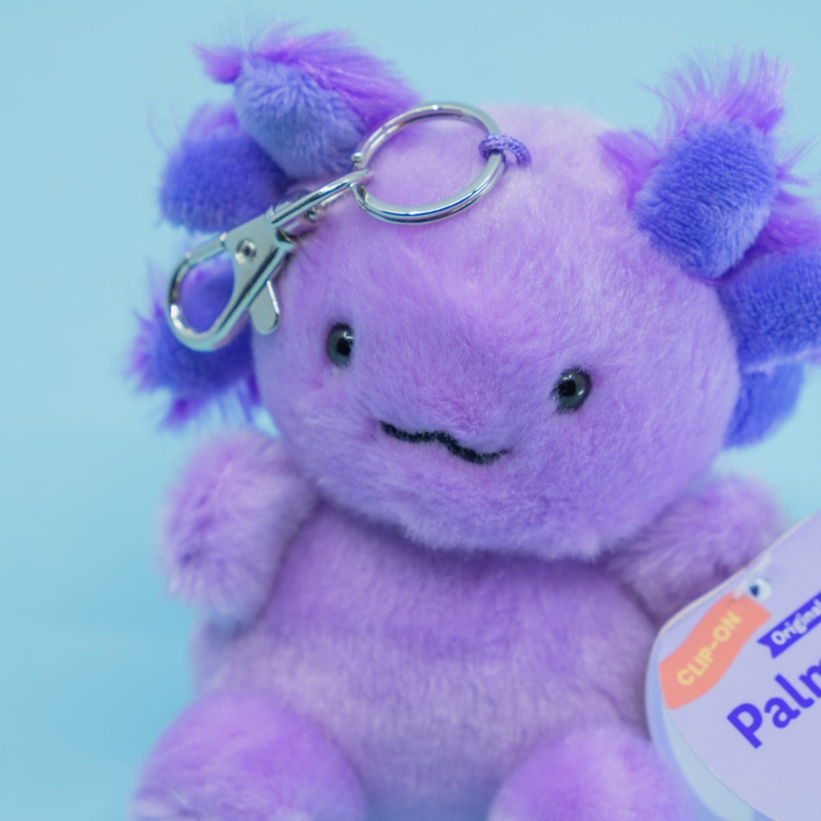 A cute blue axolotl plush key chain.