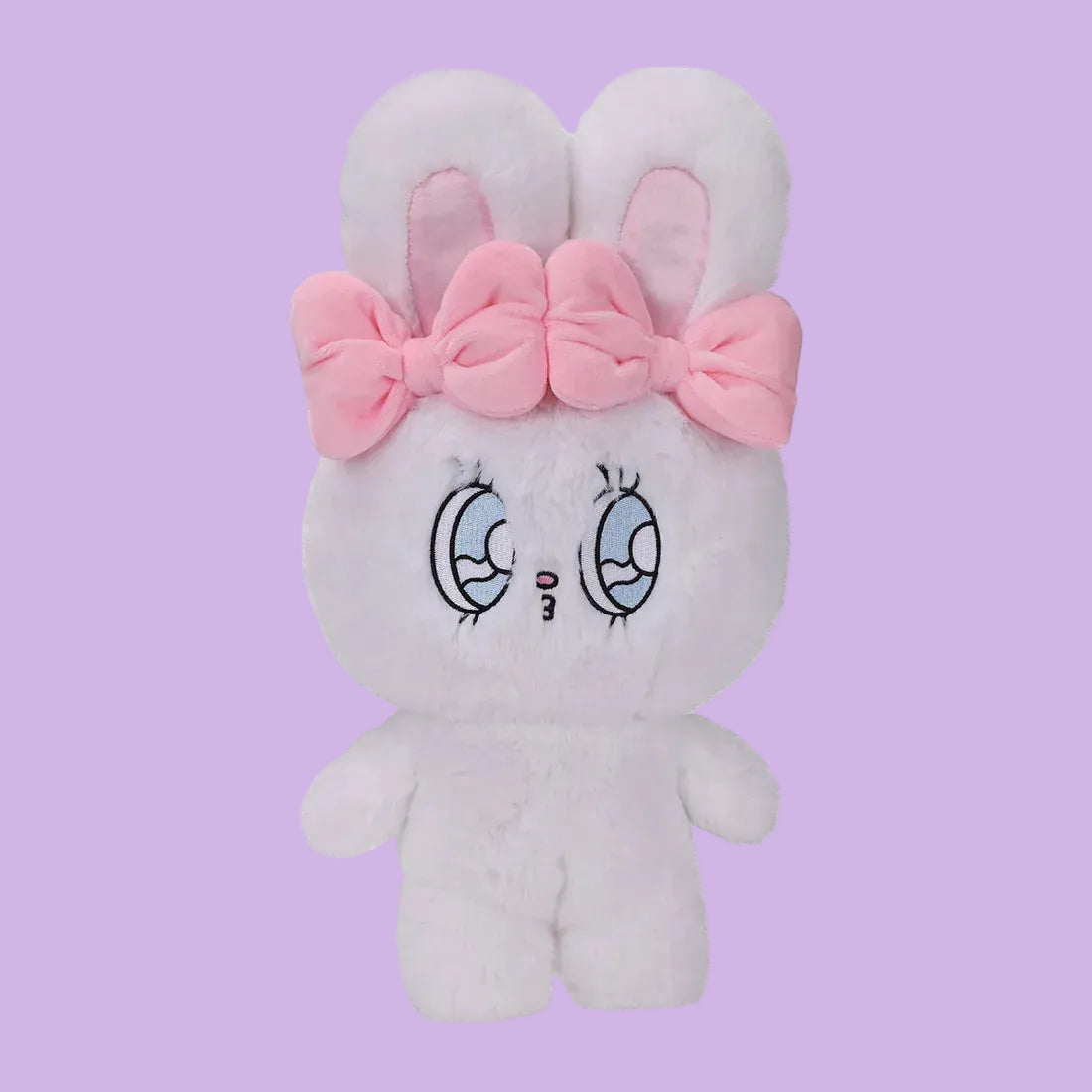 A white, fluffy rabbit plush, with big, blue eyes, and two pink bows.