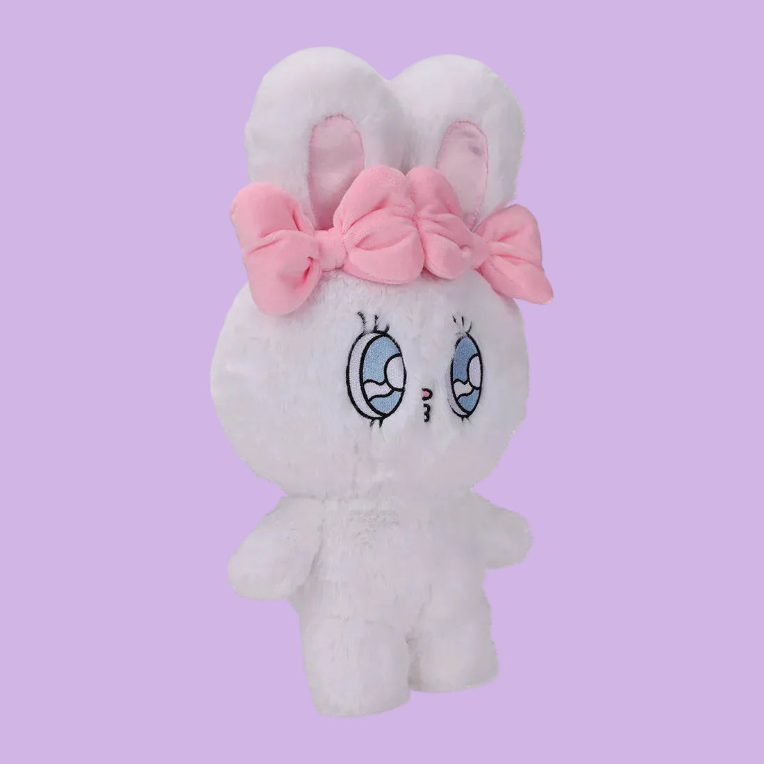 A white, fluffy rabbit plush, with big, blue eyes, and two pink bows.