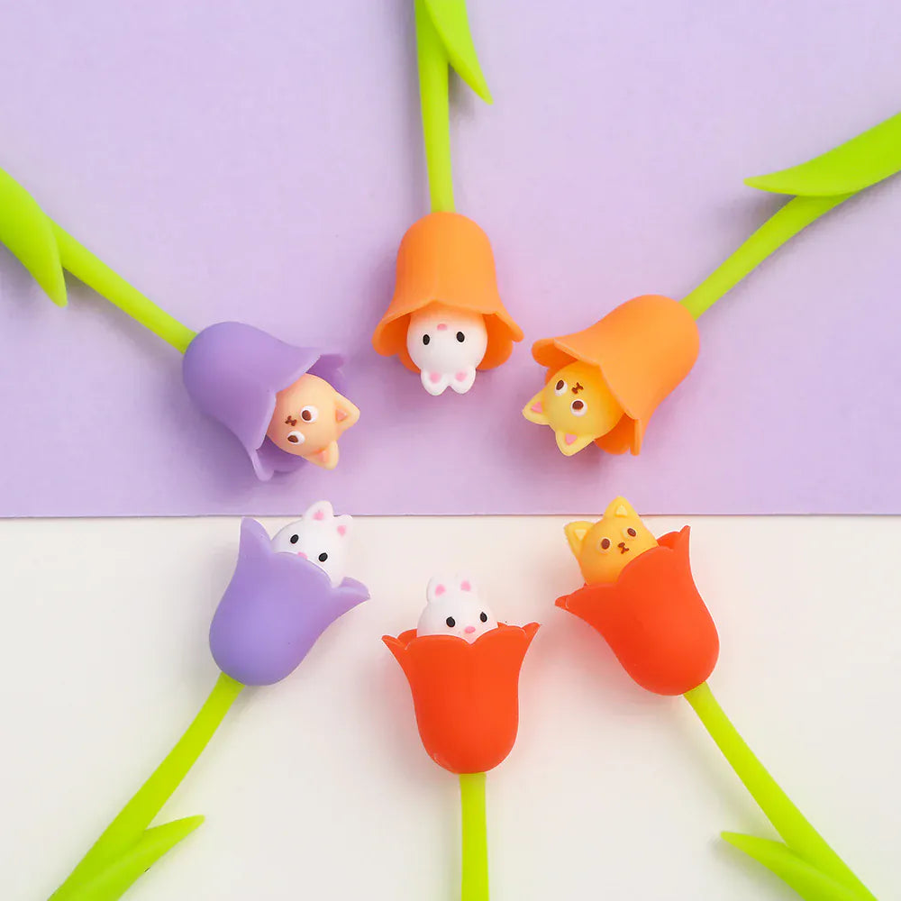Several pens designed to look like flowers with cats, and rabbits sitting in the petals.