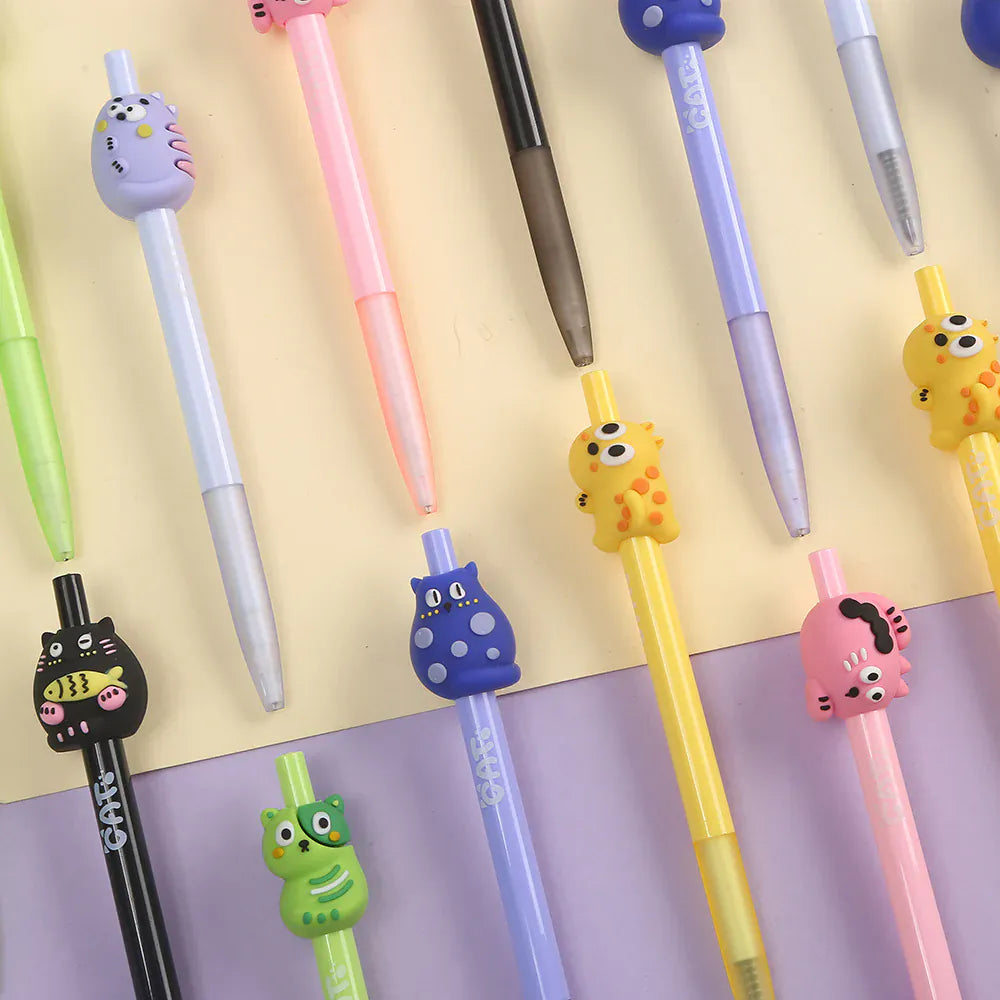 Several pens with various colorful creatures figures on their tops.