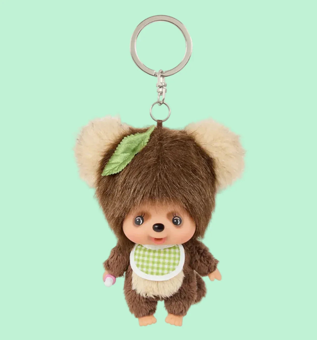 TamuTamu keychain, he has a leaf on head, and a checkered bib on the neck.