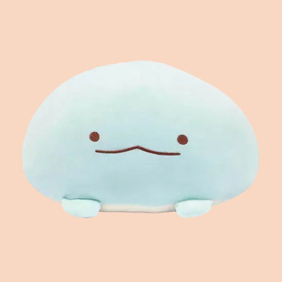 Photo of a round, blue, axolotl plush with a silly face.