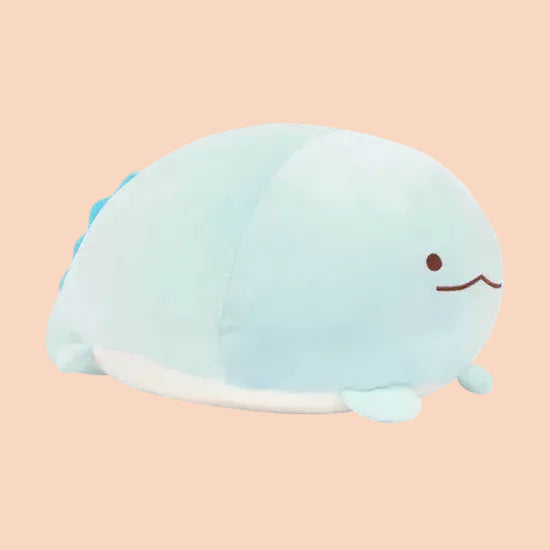 A round, blue, axolotl plush with a silly face.