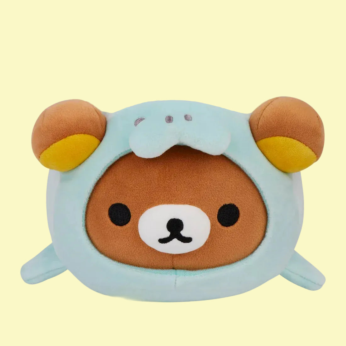 A cute, round plush of Rilakkuma wearing a seal onesie.