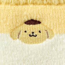 A stitching of a cute yellow dog.