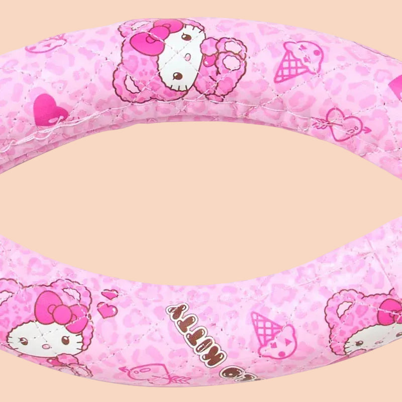 A pink cover for a steering wheel with illustrations of Hello Kitty on it.