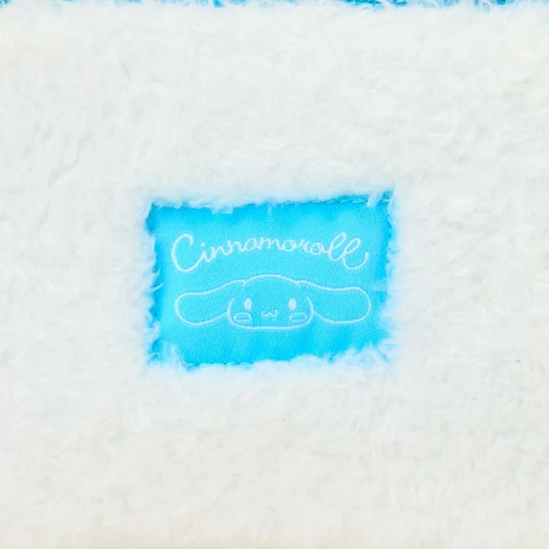 Close-up of white fabric with 'Cinnamoroll' label featuring a character design.