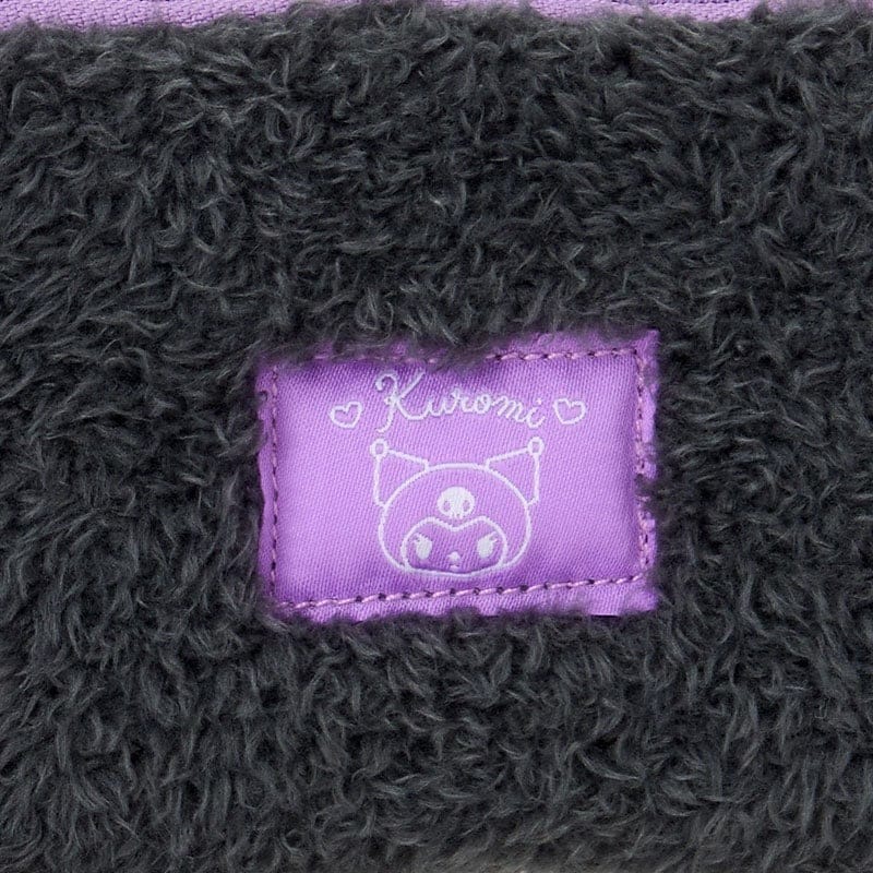 Close-up of black fabric with 'Kuromi' label featuring a character design.