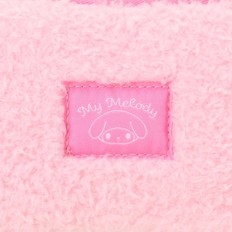 Close-up of pink fabric with 'My Melody' label featuring a character design.