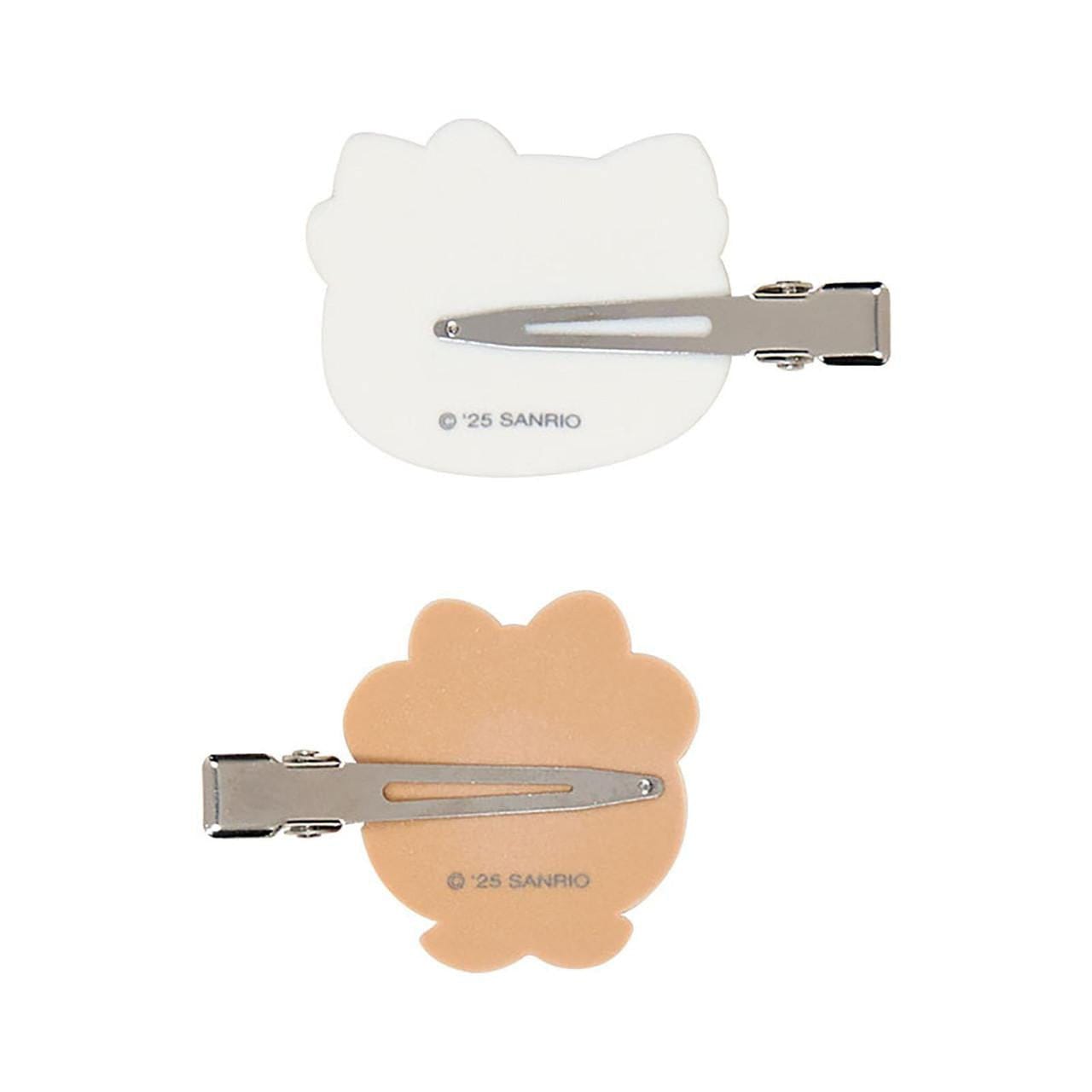 Back of hairclips that are a metal beak style. Each clip's hardware faces the opposite direction. Sanrio copyright mark shown on back of the clip.