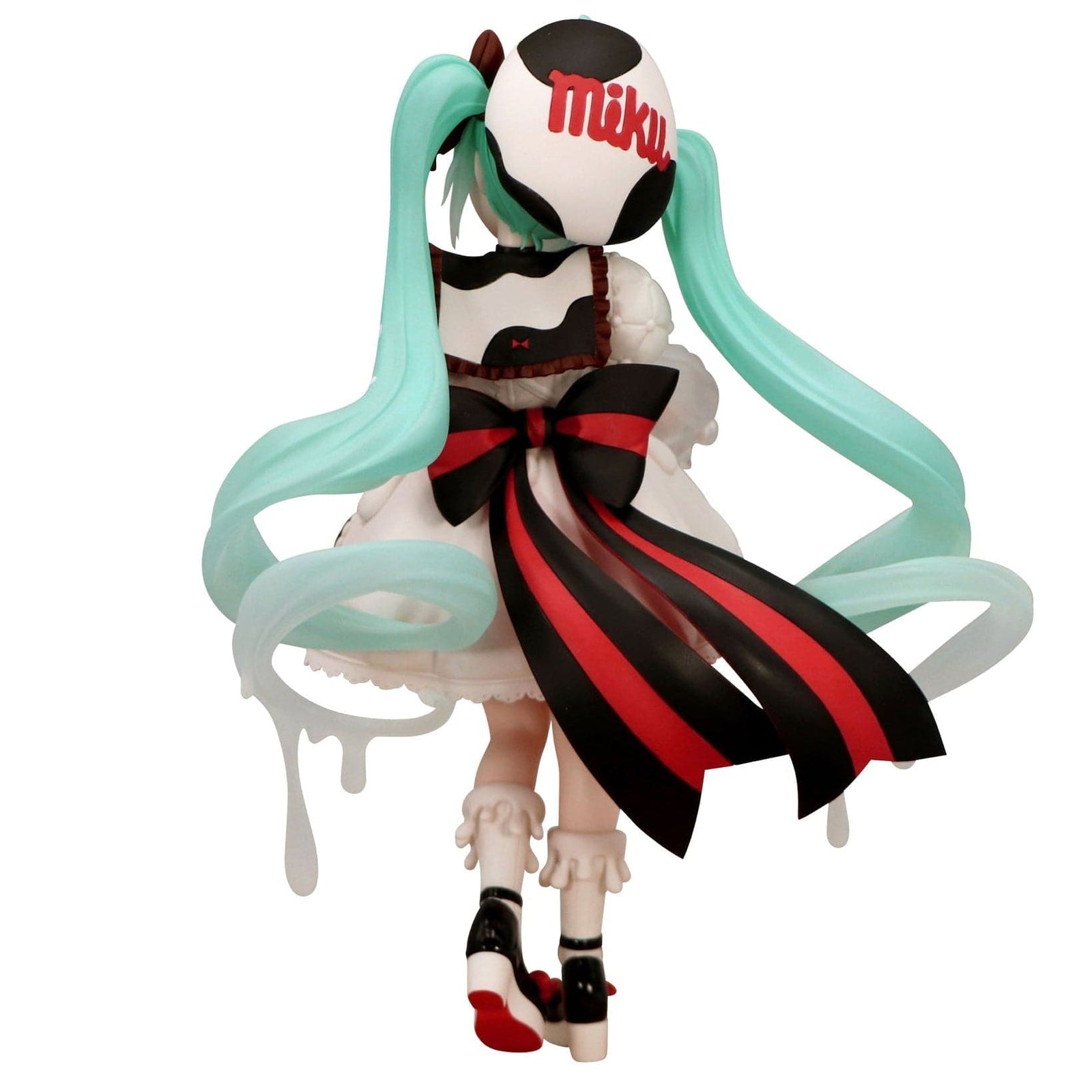 A figure of Hatsune Miku wearing a white skirt with a large red and black bow on the back.