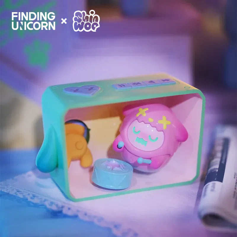 A figurine of a ghost wearing a pink animal skin. The ghost is inside a cyan box and is playing a drum.