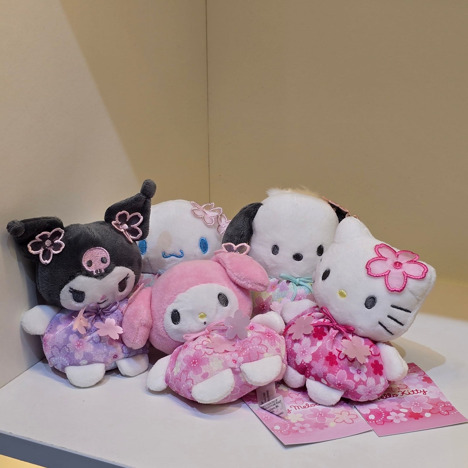A collection of San Rio plush's. There's Kuromi, Cinnamoroll, My Melody, Pochacco, and Hello Kitty.