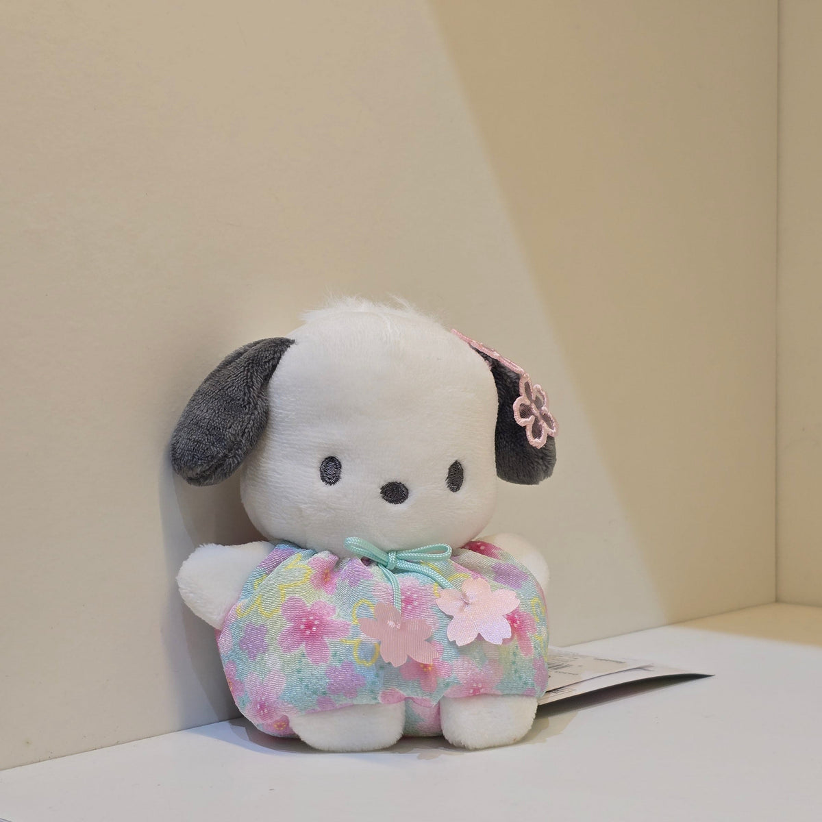 A cute Pochacco plush in a colorful flower outfit.