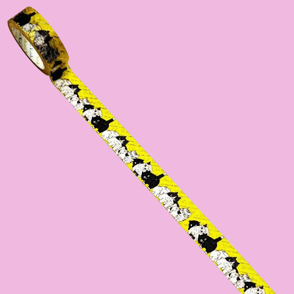 Washi tape with illustrations of many cats on a yellow background.