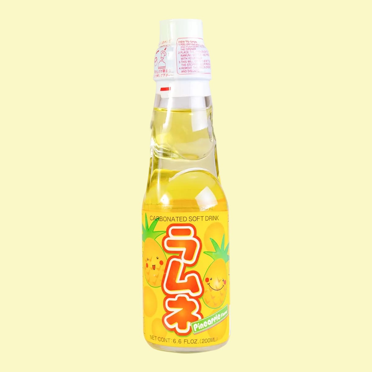 A bottle of pineapple Ramune. There are illustrations of smiling pineapples on the wrapper.
