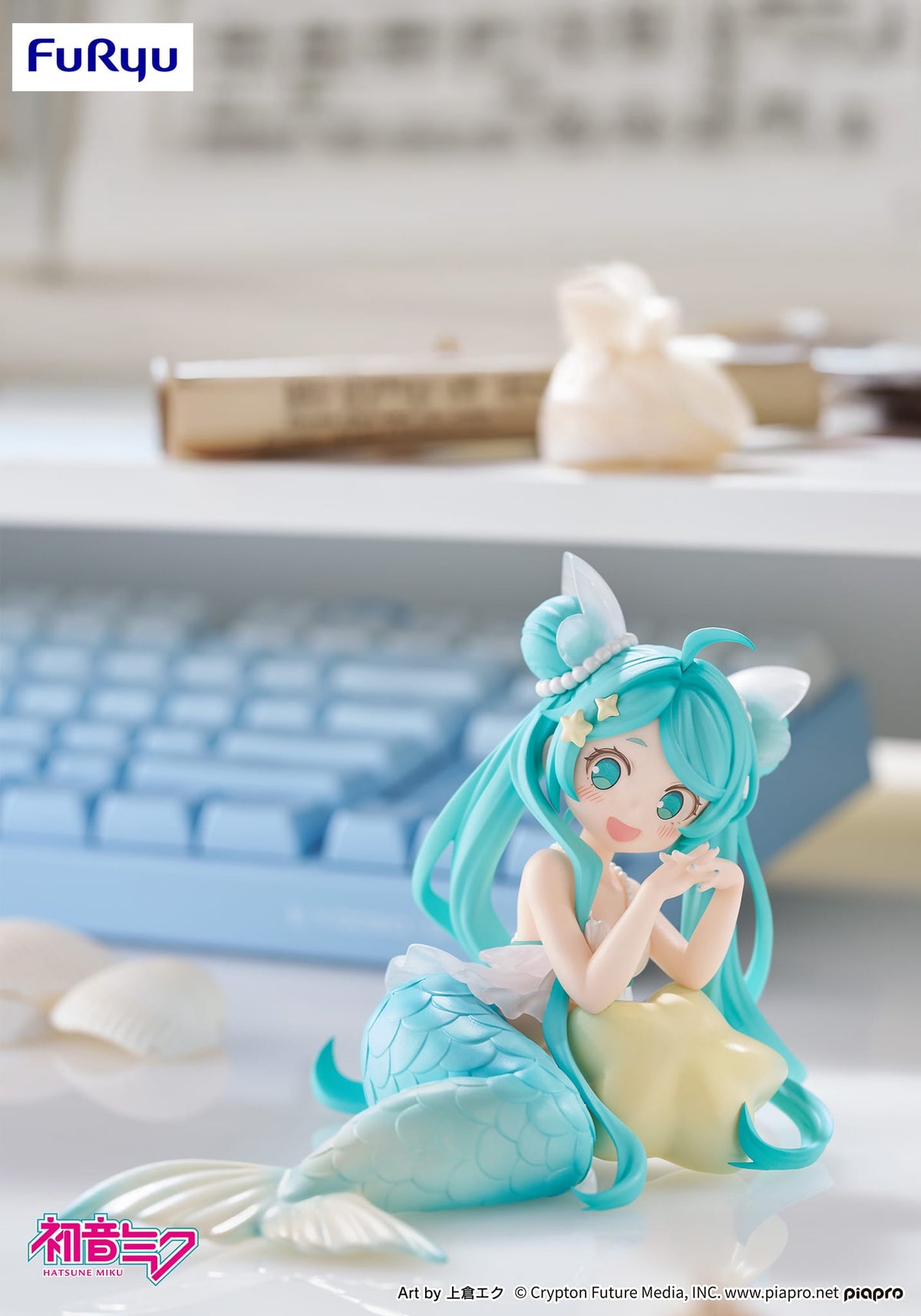 A small plastic figure of a little mermaid girl. She has long blue hair and a blue tail.