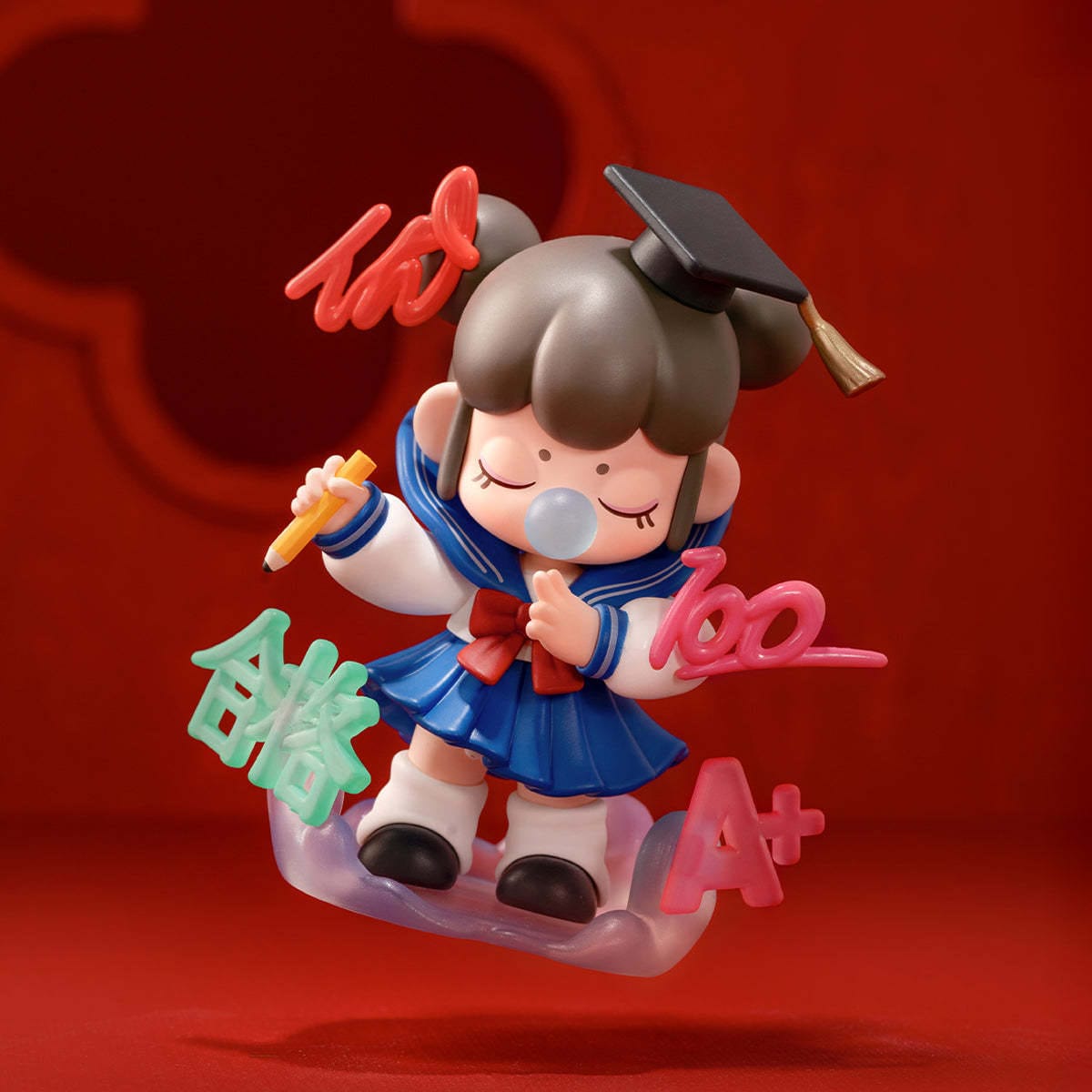 A figure of a little girl in a school outfit. She is blowing a bubble.