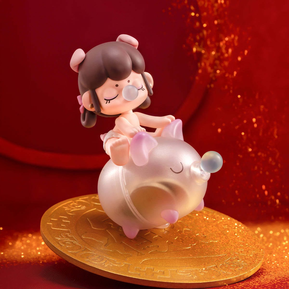 A small figure of a little girl riding a pig. both are blowing bubbles.