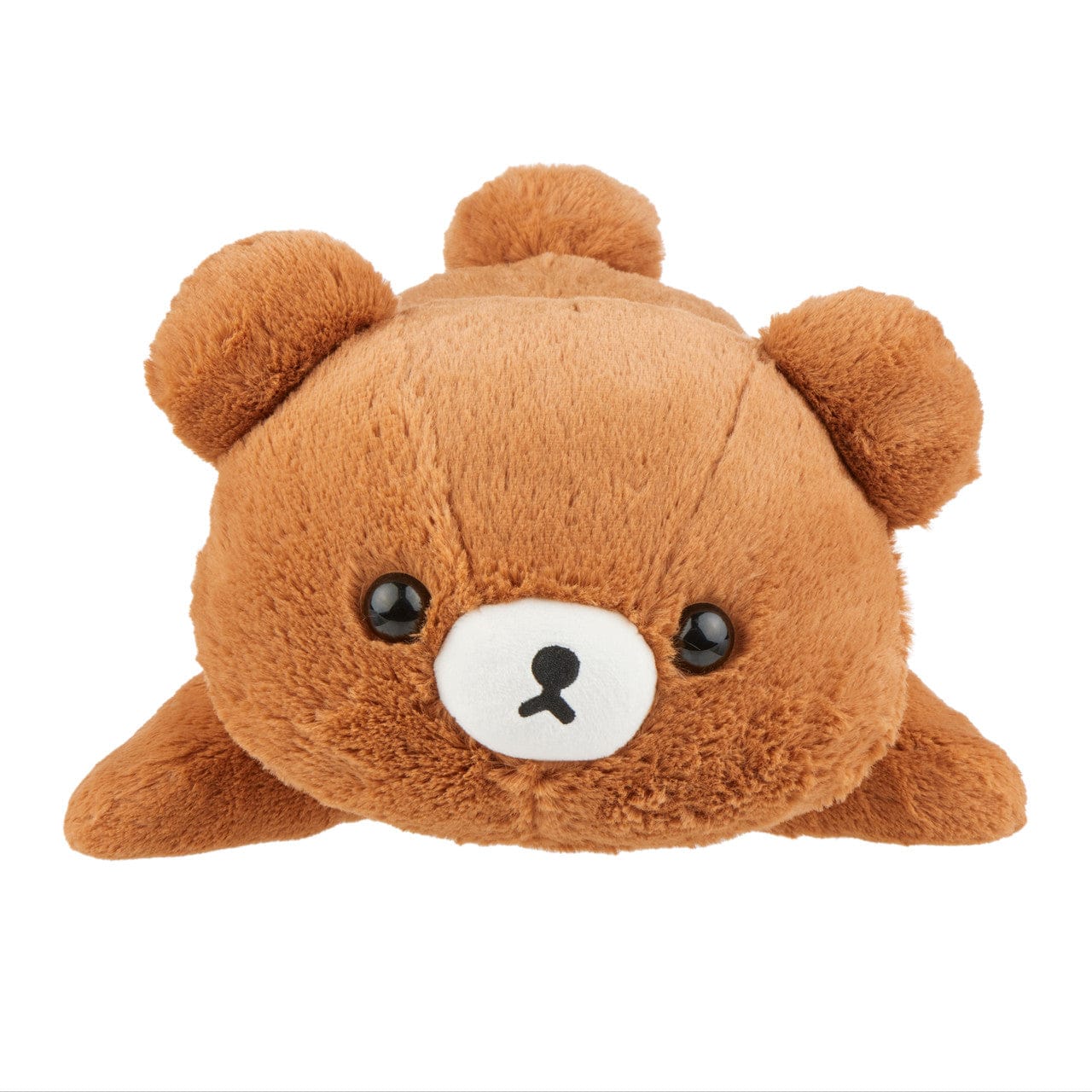 A cute brown bear plush laying on its stomach and staring sadly at the camera.