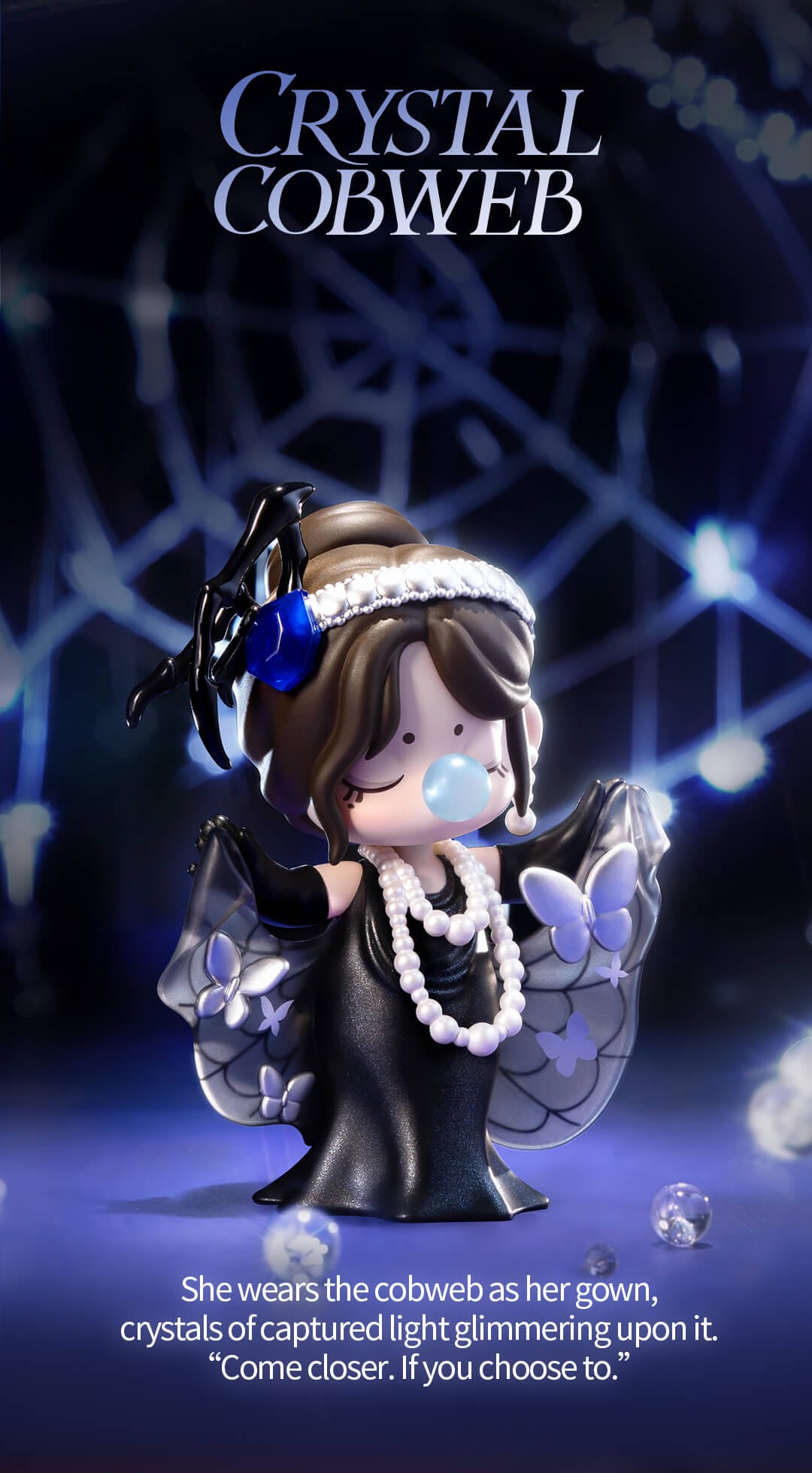Nanci wears a black dress with a translucent cobweb cape with several butterflies caught in its snare. 