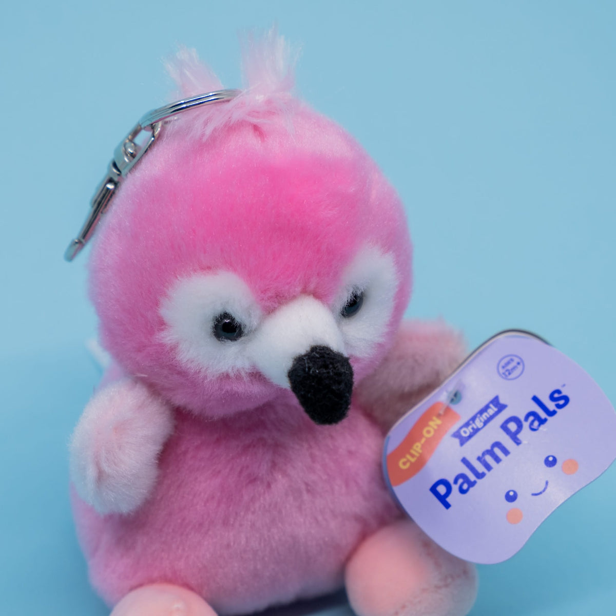 A cute flamingo plush key chain. It has a tag reading "Palm Pals".