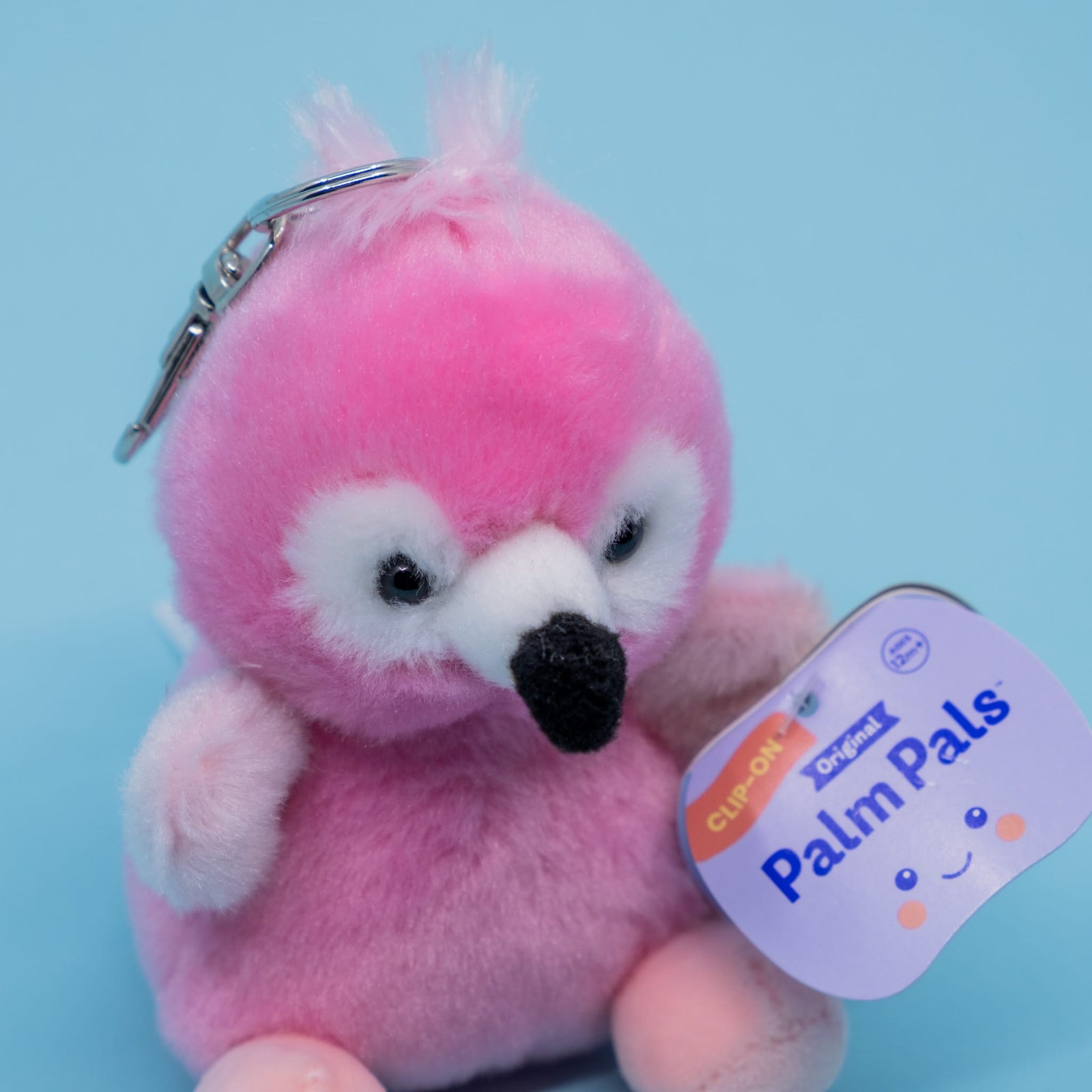 A cute flamingo plush key chain. It has a tag reading "Palm Pals".