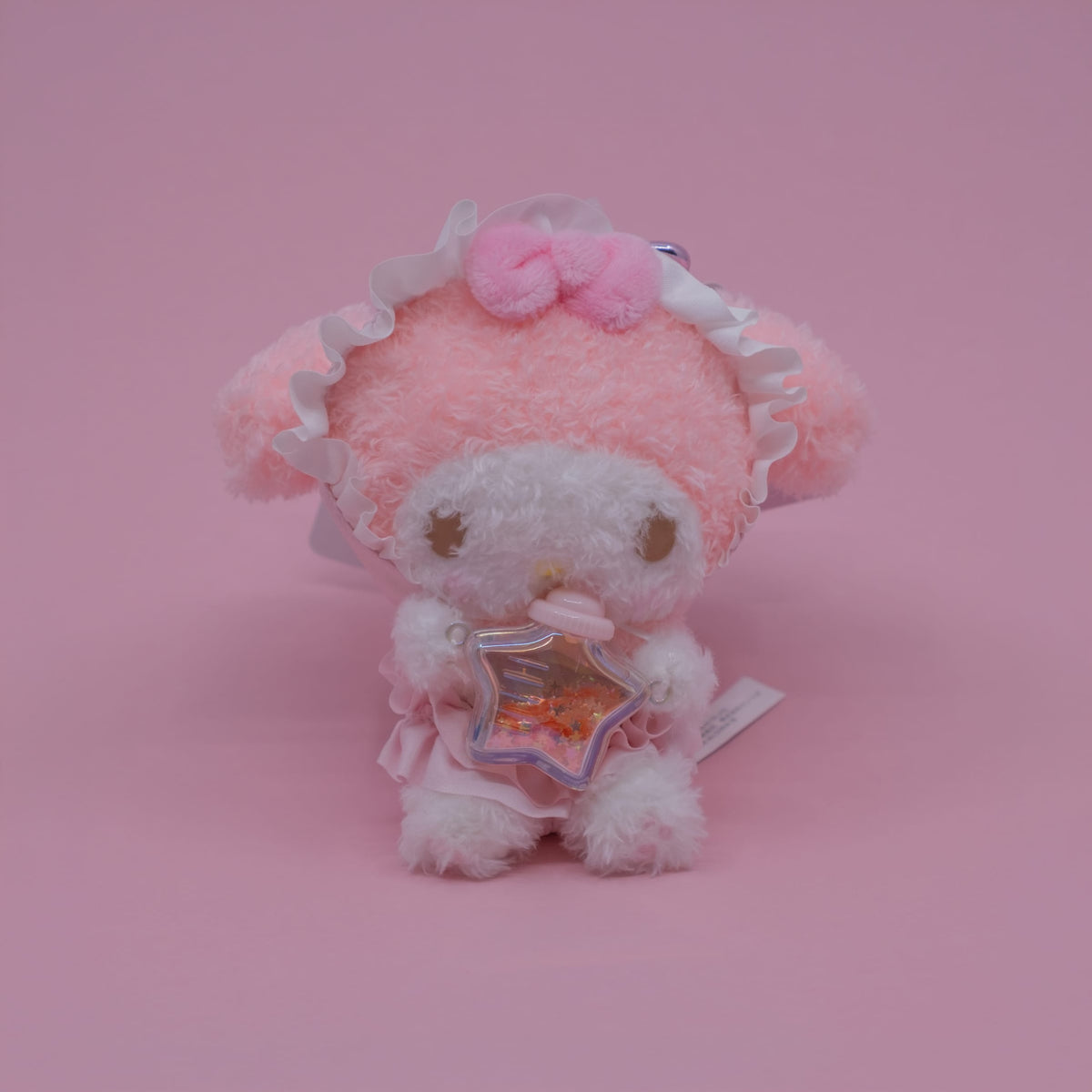 A My Melody plush key chain. She is holding a small star shaped bottle.