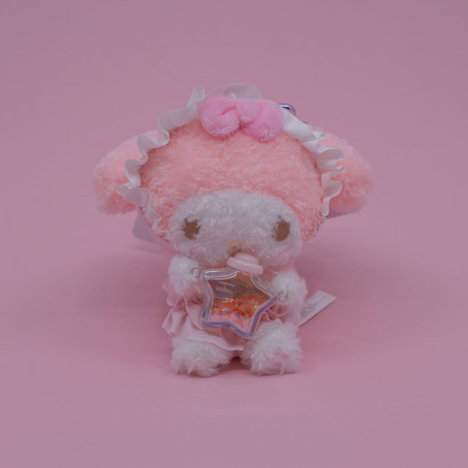 A My Melody plush key chain. She is holding a small star shaped bottle.