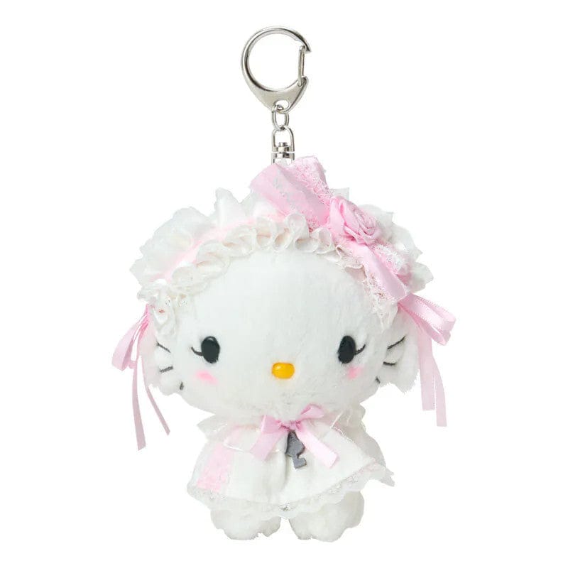 Keychain of Charmmy Kitty wearing a white dress and headpiece with charming lace details, delicate frills, and sweet pink touches. Hardware is silver.
