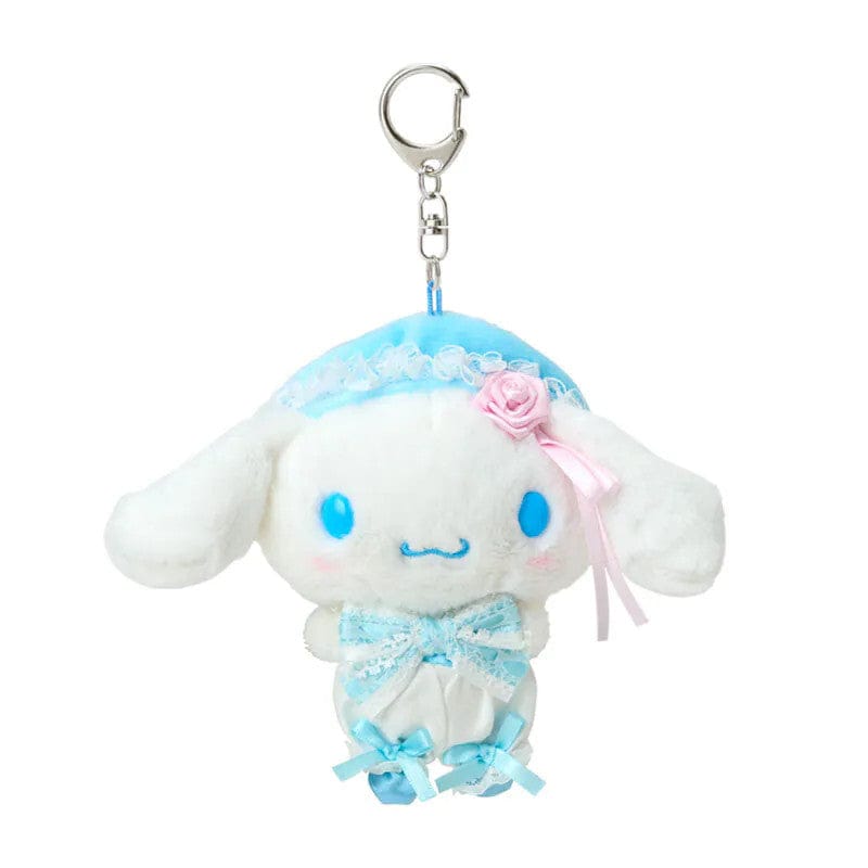 Keychain of Cinnamoroll wearing a white and blue outfit and beret with charming lace details, delicate frills, and sweet pink touches. Hardware is silver.
