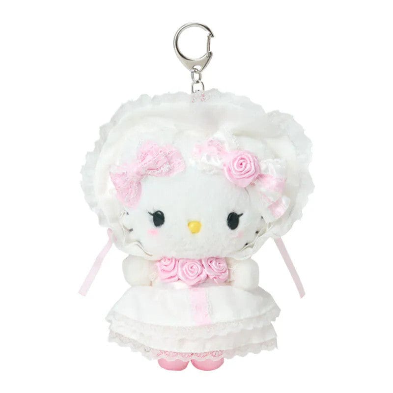 Keychain of Hello Kitty wearing a white dress and bonnet with charming lace details, delicate frills, and sweet pink touches. Hardware is silver.