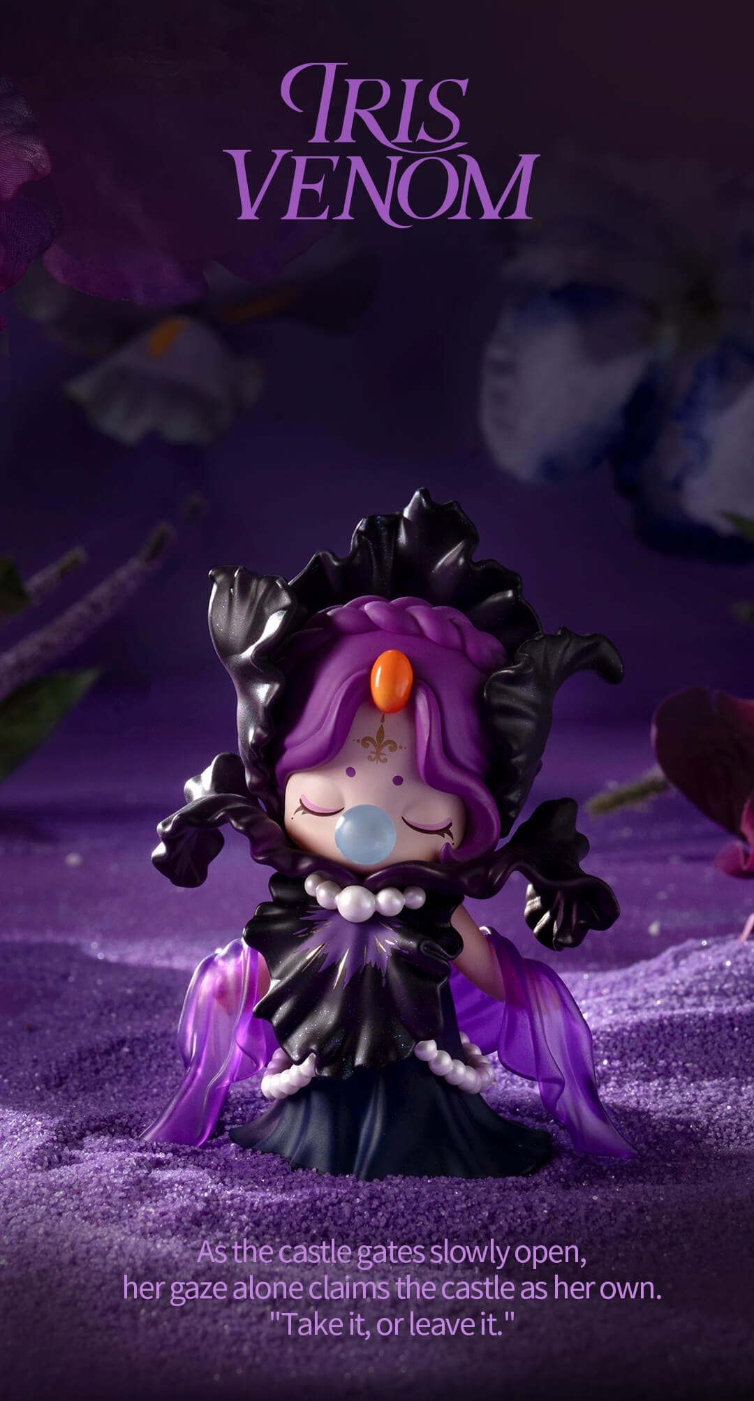 Nanci wears a black iris dress and hooded cape with pearls and a translucent shawl draped across her arms