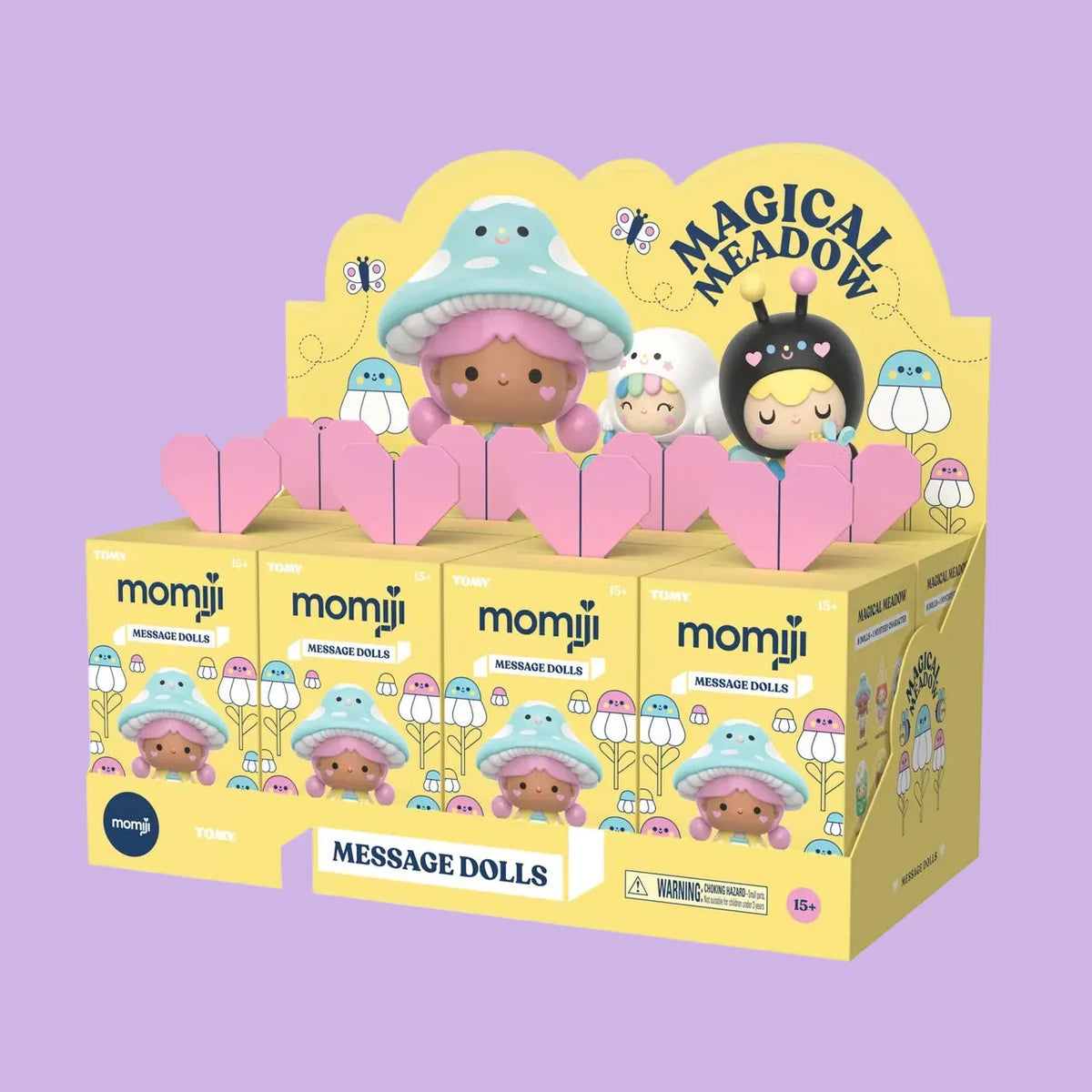 A case of Momiji Magical Meadow message doll blind boxes. The boxes are yellow and have an image of a girl with a mushroom hat on them.