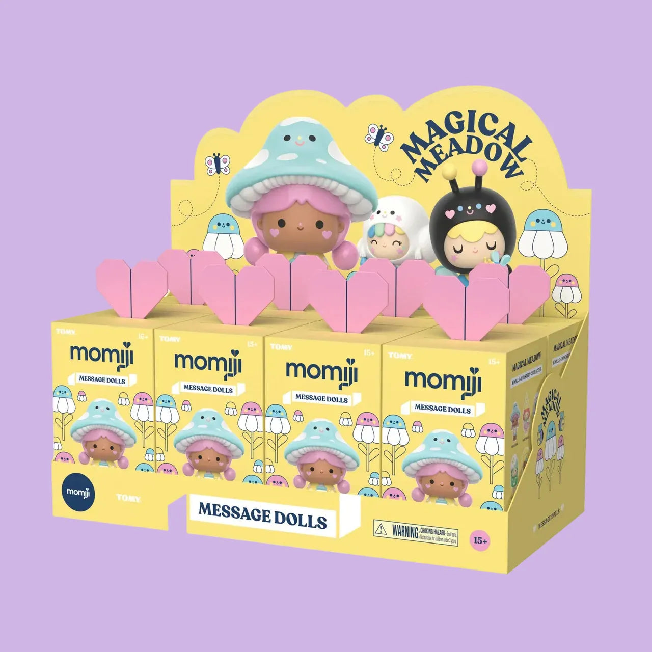 A case of Momiji Magical Meadow message doll blind boxes. The boxes are yellow and have an image of a girl with a mushroom hat on them.