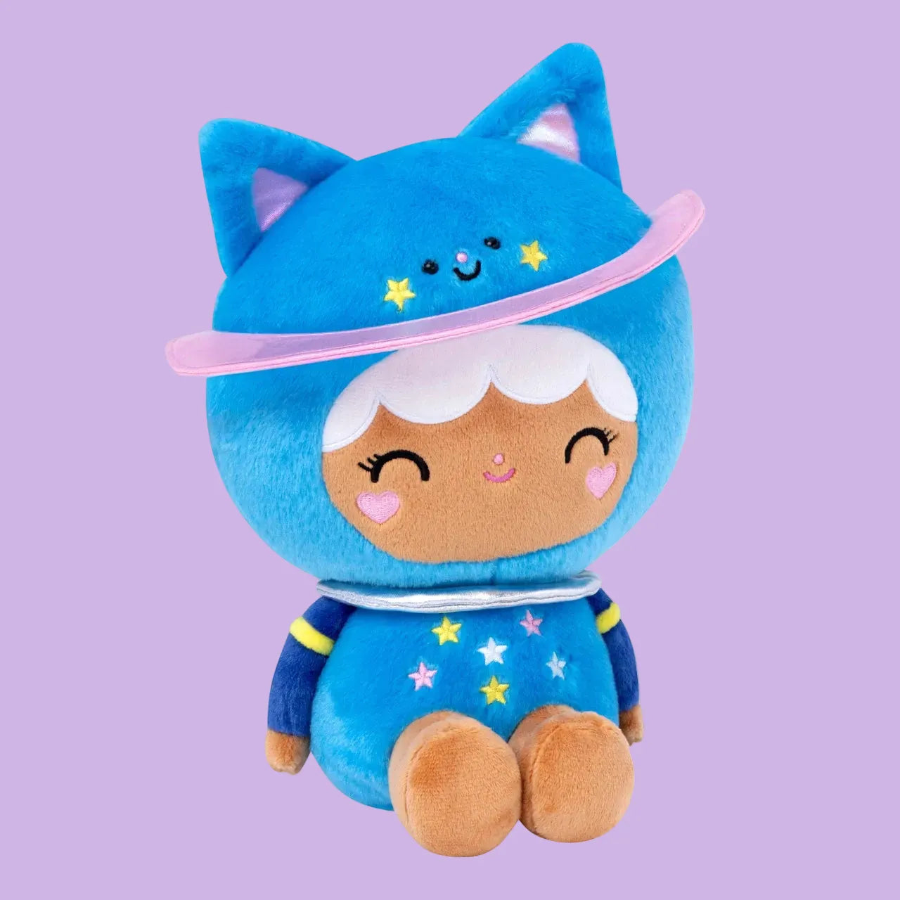 A cute plush of a girl in a blue, space themed, cat onesie. She is sitting on the floor and smiling.