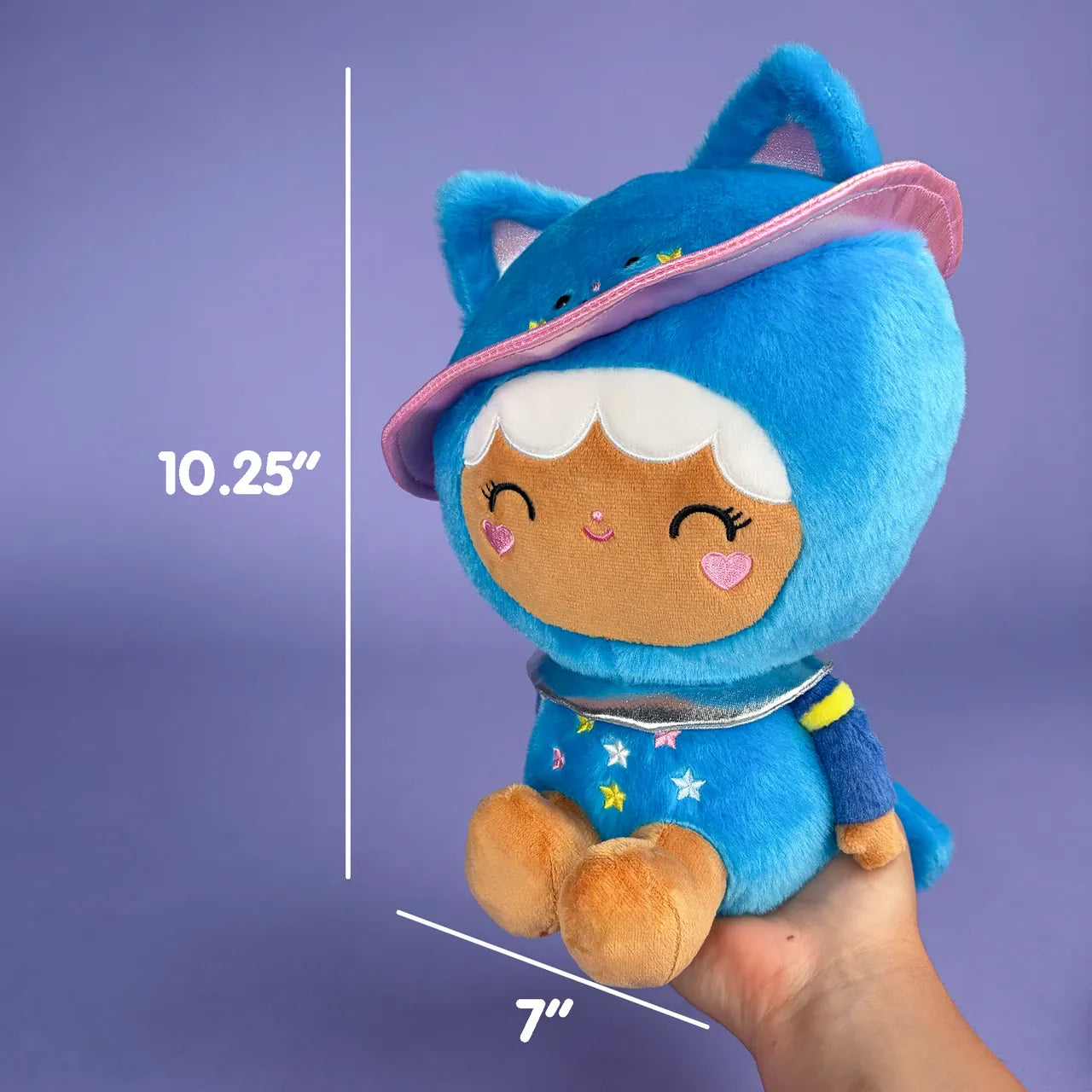 A cute plush of a girl in a blue, space themed, cat onesie. There are measurements showing she is 10.25 inches tall and 7 inches wide.