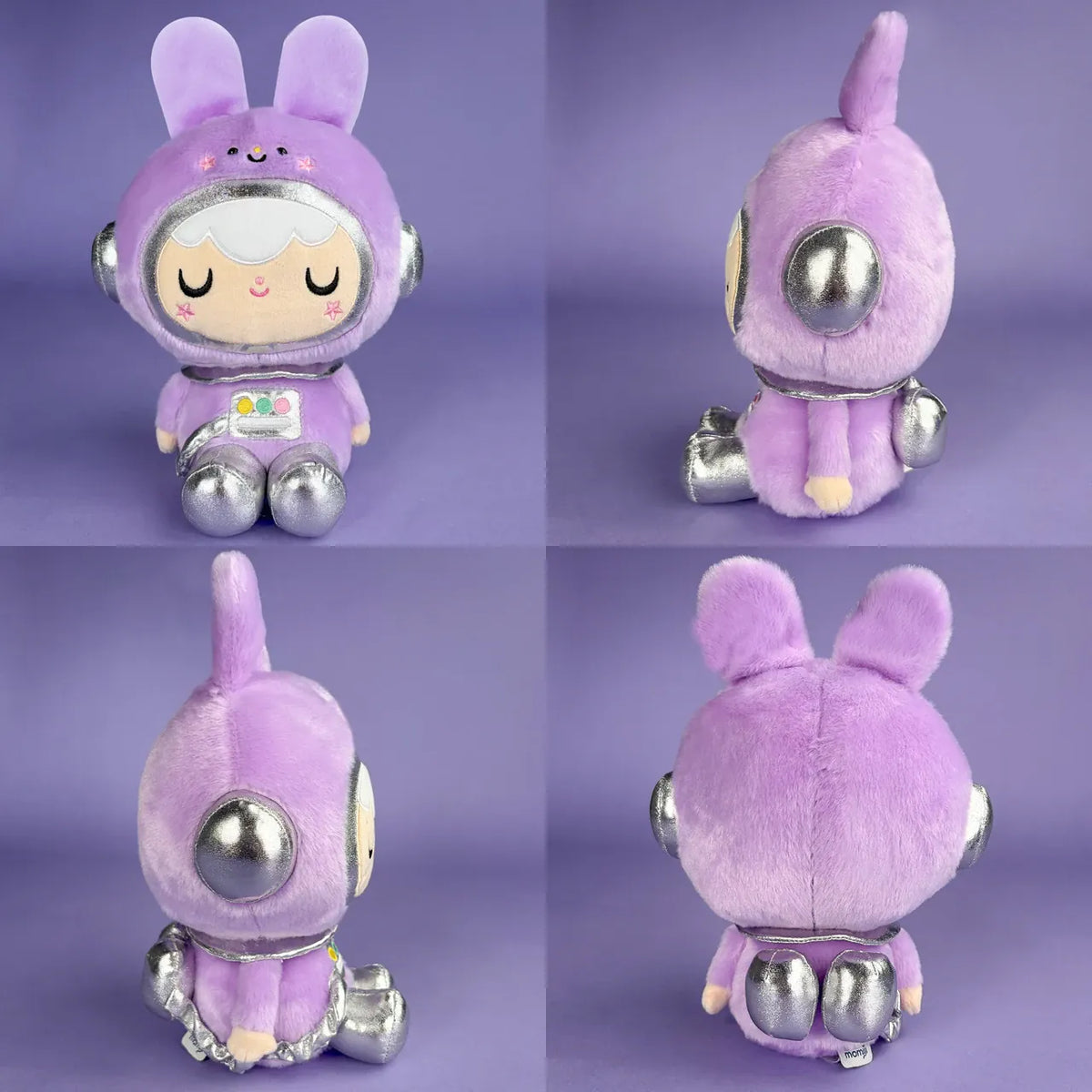 A cute plush of a girl in a purple, space themed, bunny outfit. She is sitting on the floor and smiling.