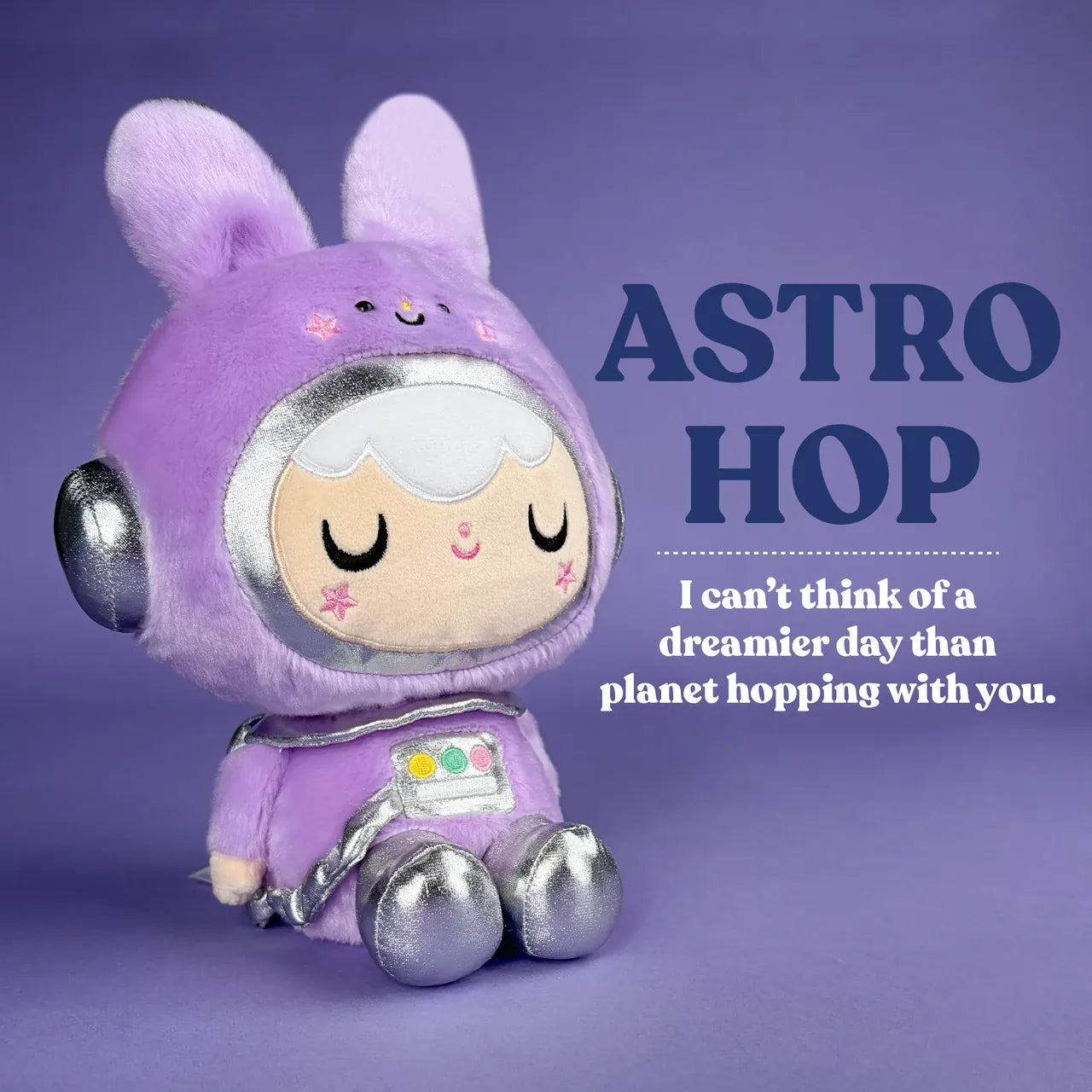 A cute plush of a girl in a purple, space themed, bunny outfit. There is text reading "Astro Hop. I can't think of a dreamier day than planet hopping with you".