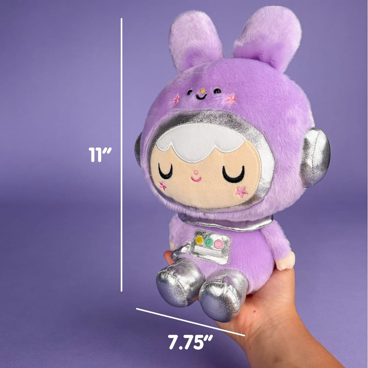 A cute plush of a girl in a purple, space themed, bunny outfit. There are measurements showing she's 11 inches tall and 7.75 inches wide.