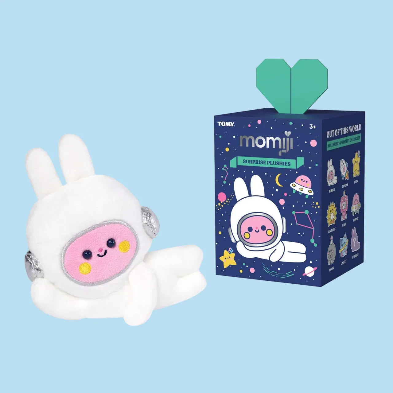A cute plush of a rabbit in a space suit lounging beside a blind box containing various other space themed plushies.