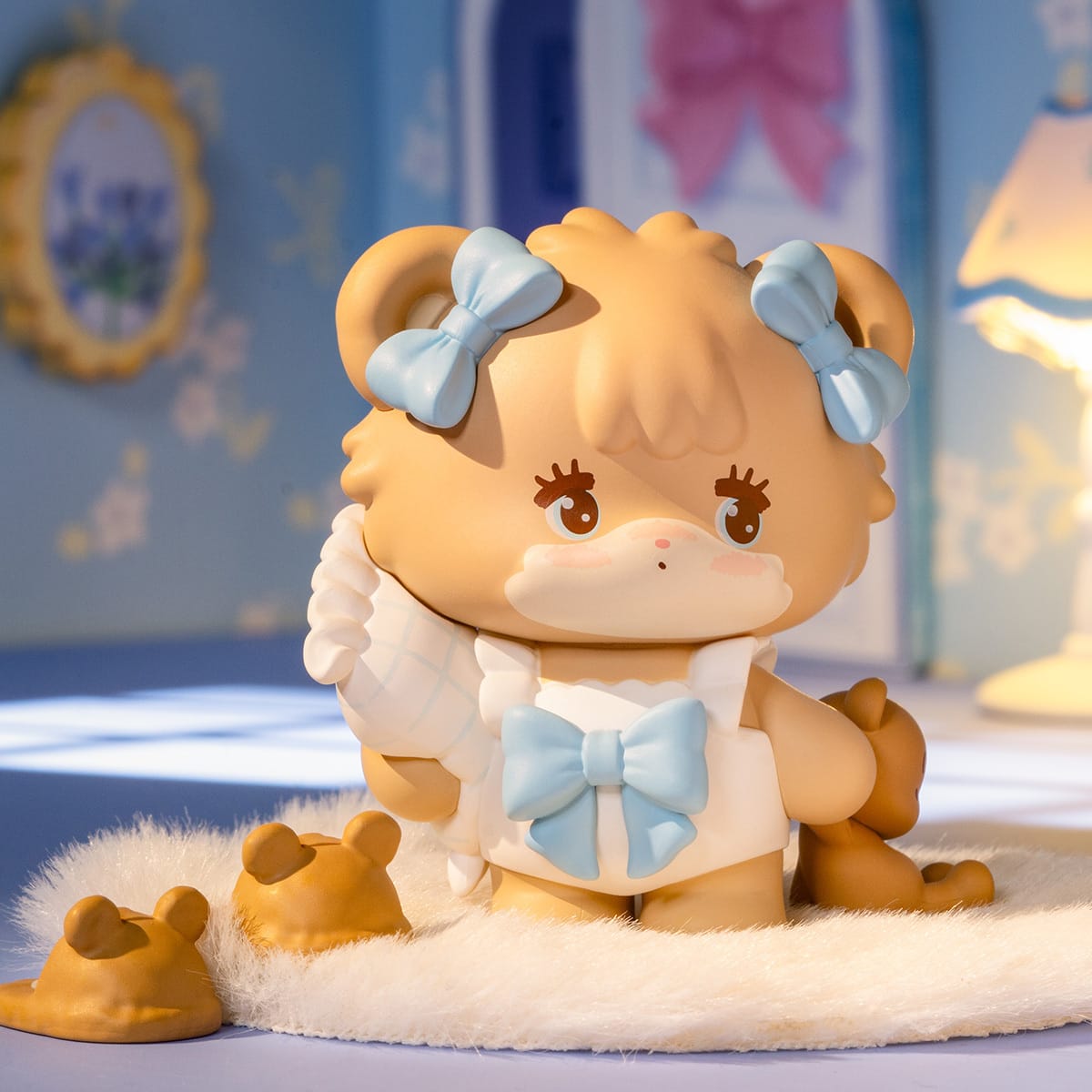 A figure of a little dog with blue ribbons on its ears.