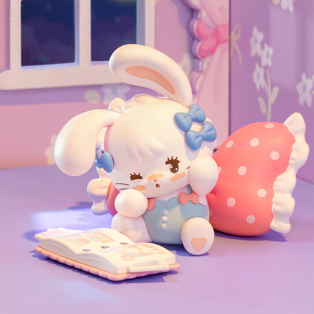 A small figure of a cute anthropomorphic rabbit looking stressed while trying to read a book.  They have little blue bows in their hair.