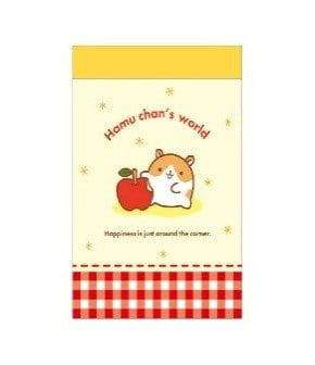 A notepad with a cute illustration of a hamster next to an apple on it.