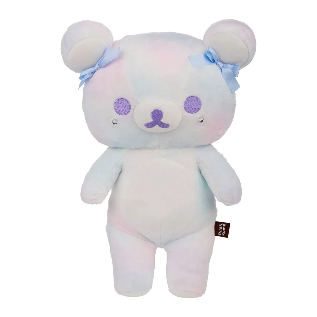 A white bear plush with blue bows on its ears.