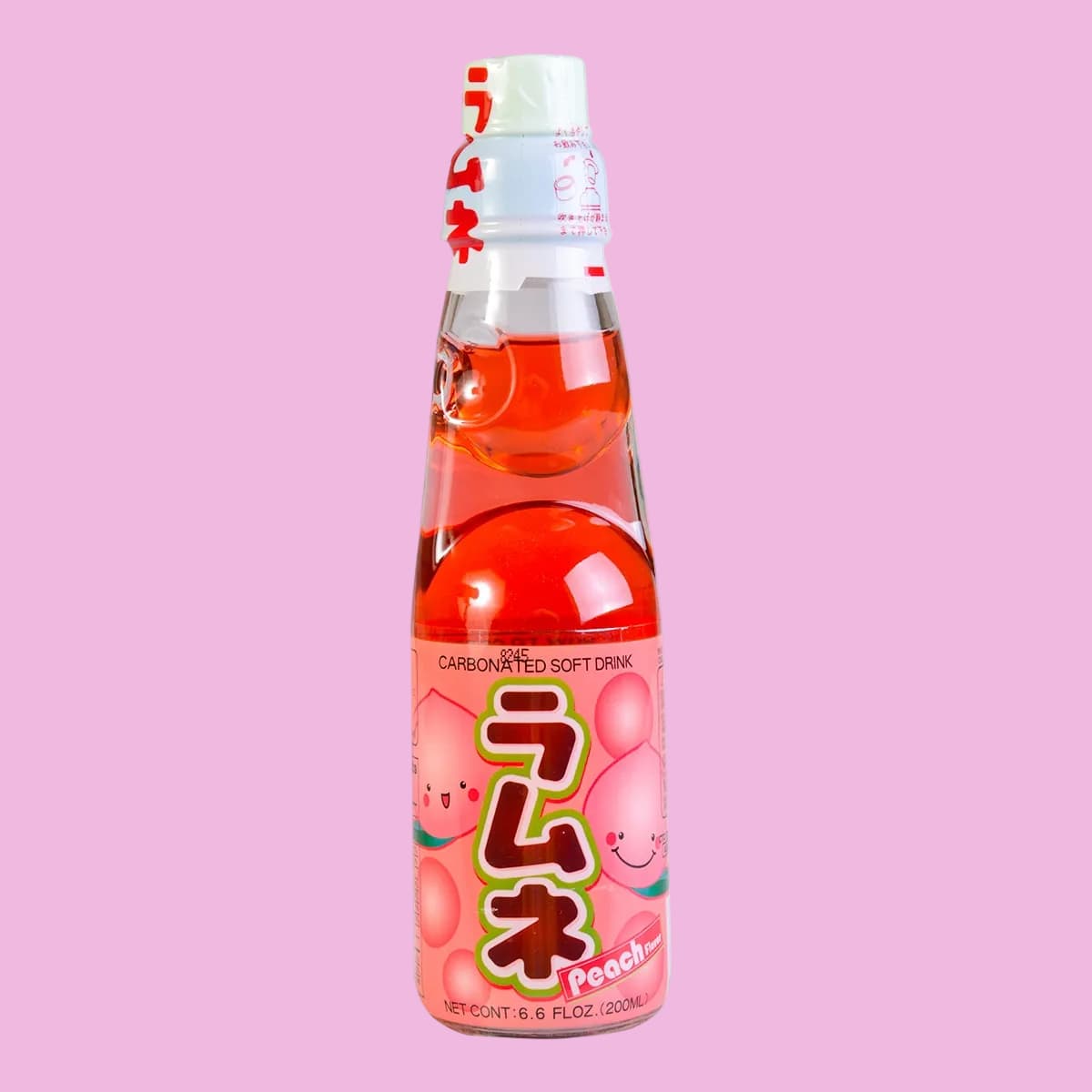 A bottle of peach Ramune. There are illustrations of smiling peaches on the wrapper.