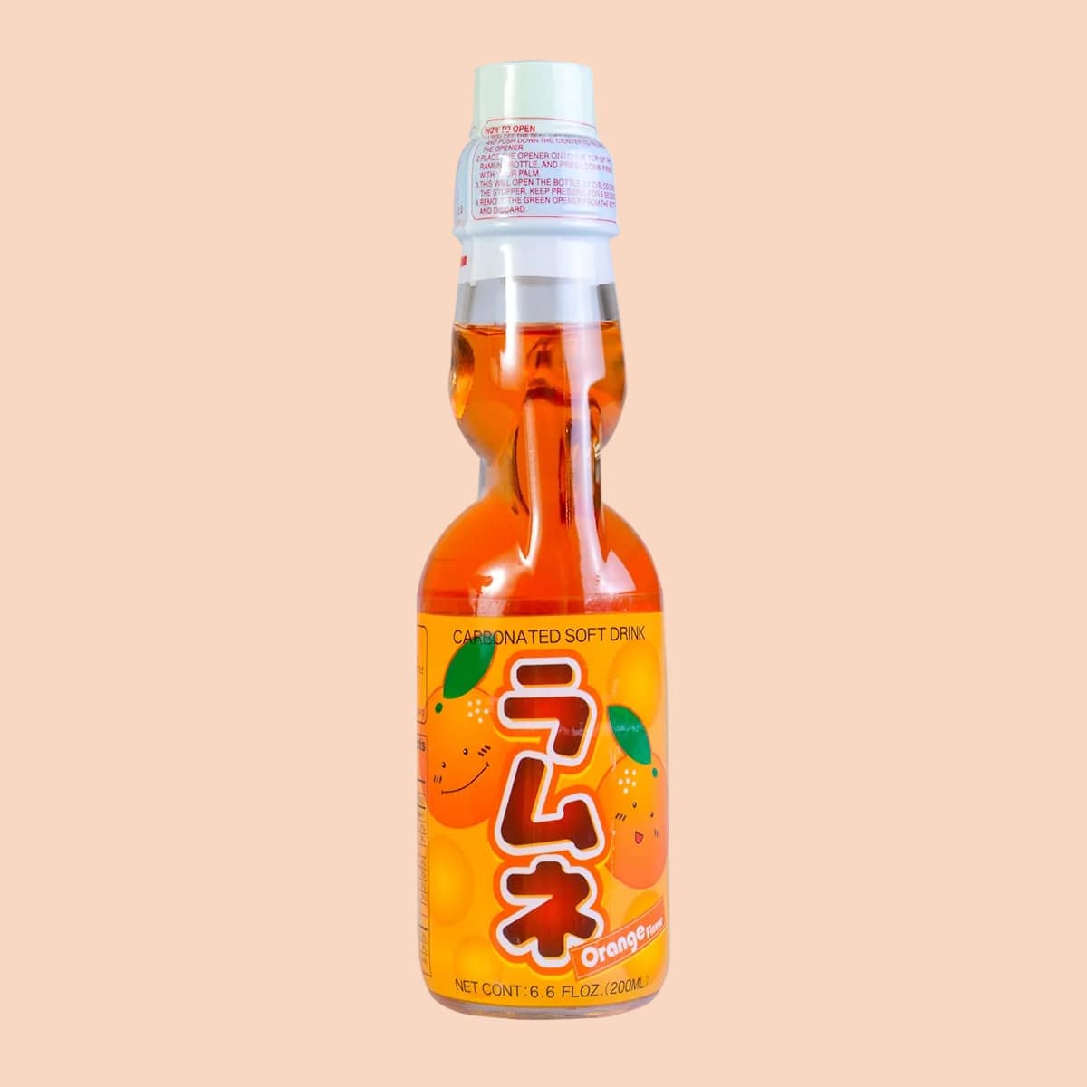 A bottle of orange Ramune. There are illustrations of smiling oranges on the wrapper.